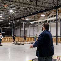 An alumnus throwing a football at the Fowling Fun Event